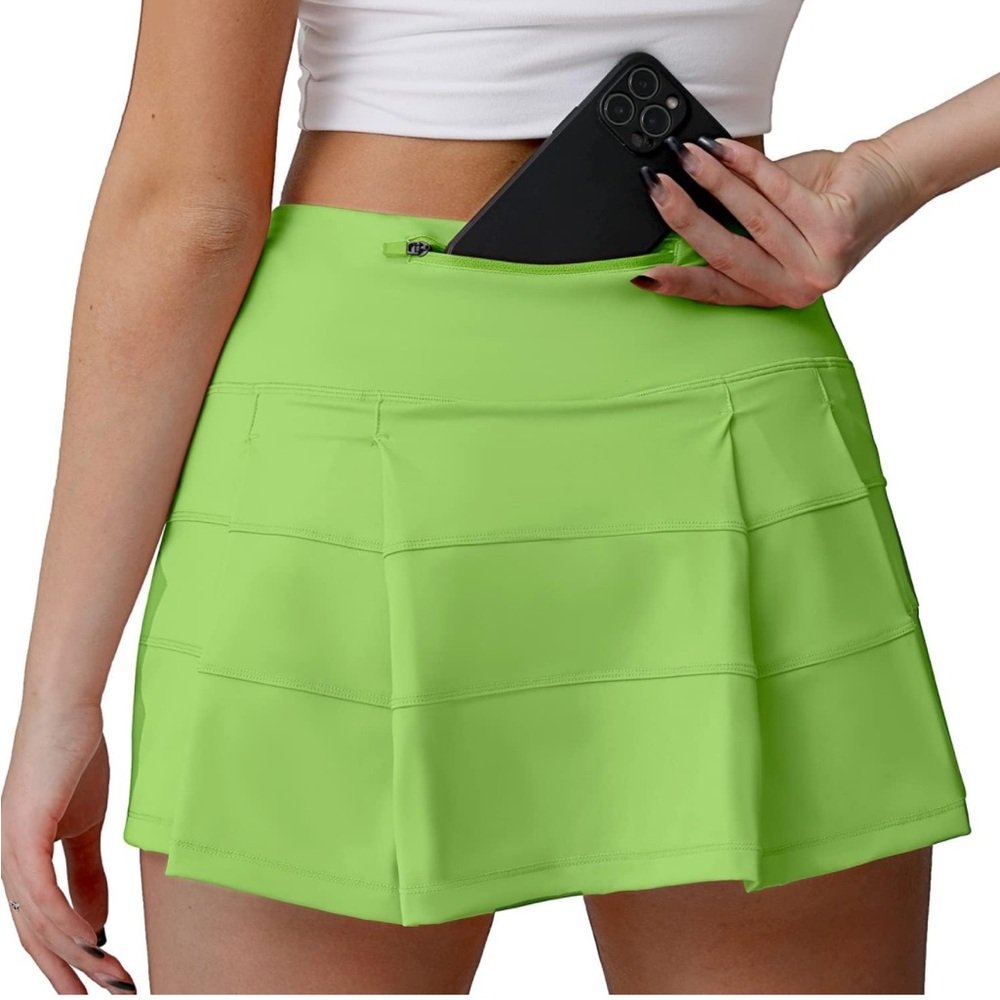 Husnainna high waisted pleated tennis skirt with pockets. Lime green.